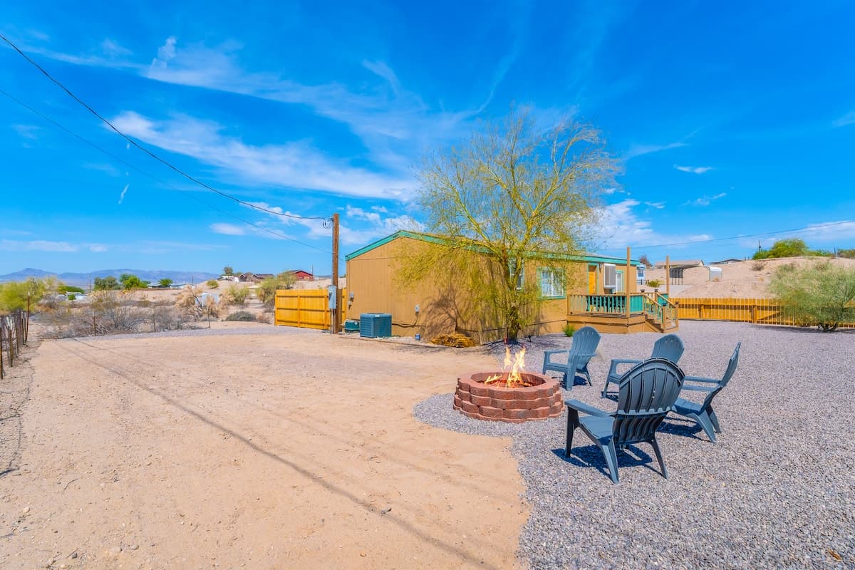 Outdoor chairs and fire pit in the gravel yard