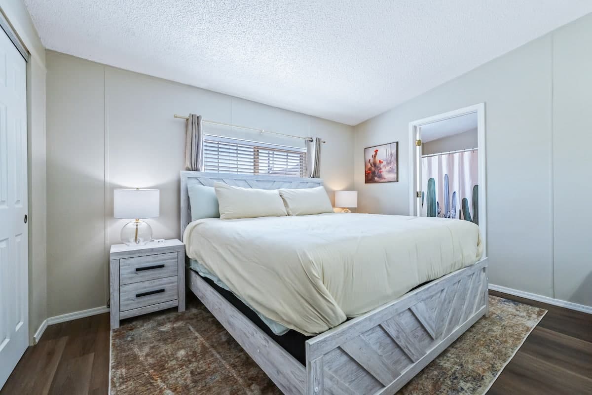 King bed with white bedding in the primary bedroom