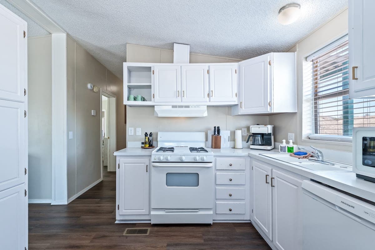 White kitchen with cabinets, oven and countertop