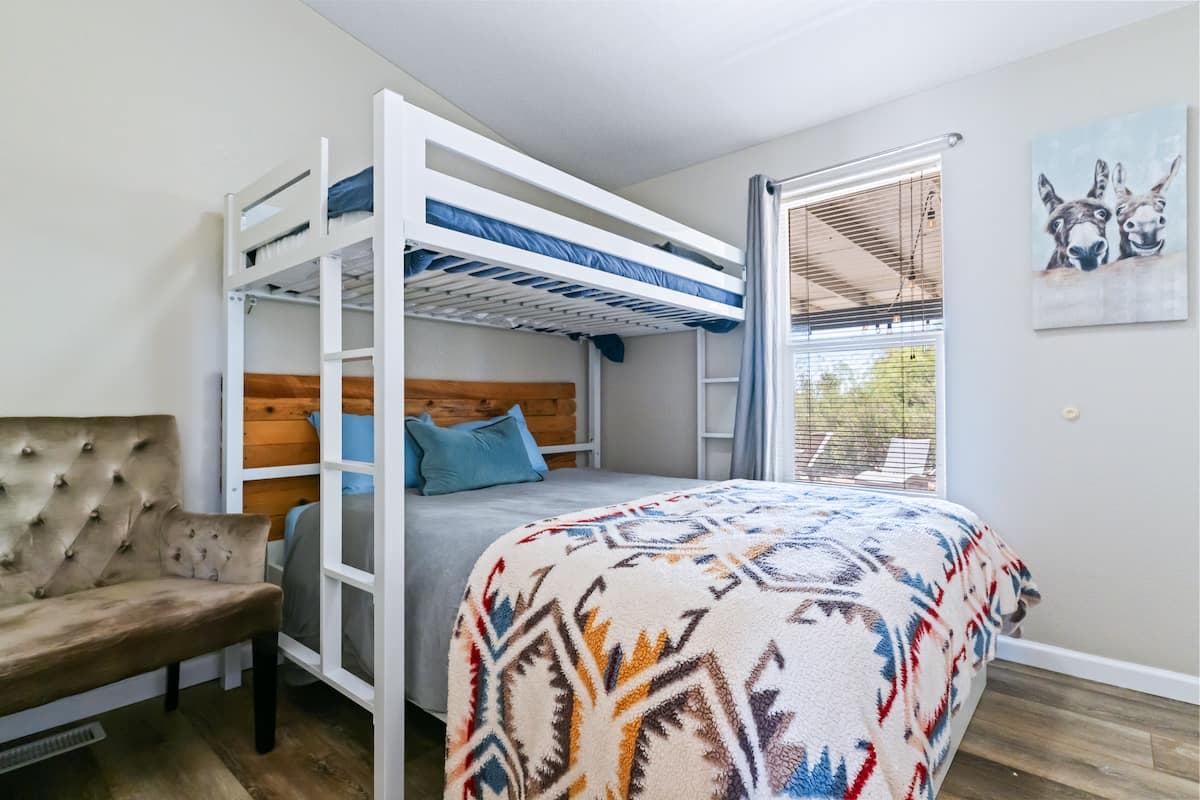 Bunk bed with two sleeping spaces and patterned bedding